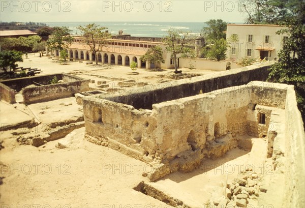 A courtyard inside Fort Jesus. Crumbling stone walls and foundations criss-cross a courtyard inside Fort Jesus. Mombasa, Kenya, April 1964. Mombasa, Coast, Kenya, Eastern Africa, Africa.