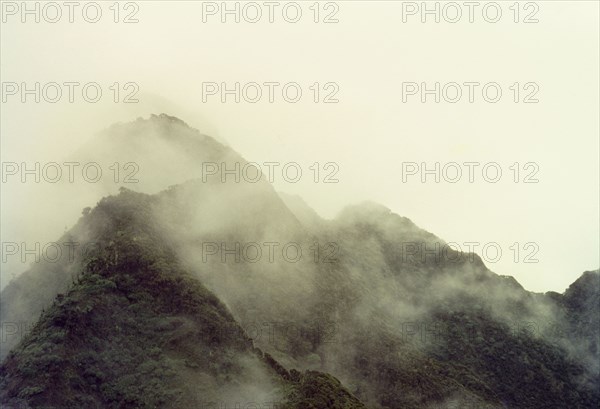 Mount Sabinyo in cloud. The summit of Mount Sabyinyo (Sabinio) enshrouded by clouds. Kigezi, South West Uganda, September 1963., West (Uganda), Uganda, Eastern Africa, Africa.