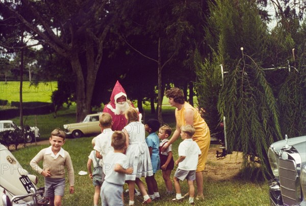 Meeting Father Christmas at Mbarara. A group of European children queue eagerly to meet Father Christmas during Christmas celebrations at Mbarara in Ankole. Mbarara, South West Uganda, December 1963., West (Uganda), Uganda, Eastern Africa, Africa.