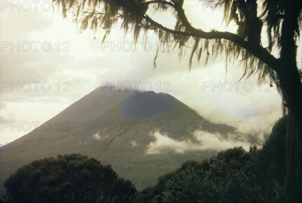 Clouds over Mount Muhabura. Heavy clouds hang over Mount Muhabura (Muhavura), an extinct volcano in the Virunga Mountains. Kigezi, South West Uganda, 1962., West (Uganda), Uganda, Eastern Africa, Africa.