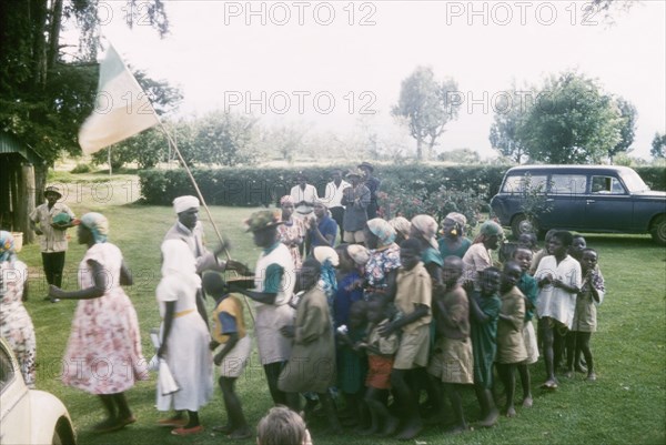 Christmas games. Children prepare for Christmas games outdoors at the Afro-Israel Mission. Kapsimotwa, Kenya, December 1961., Rift Valley, Kenya, Eastern Africa, Africa.