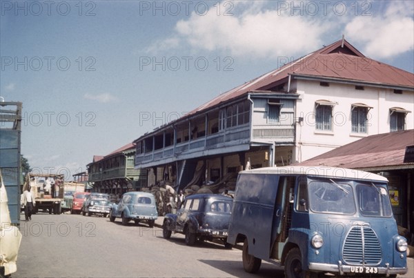 Kampala bazaar. Kampala Road with parked cars in the bazaar. Kampala, Uganda, 1960. Kampala, Central (Uganda), Uganda, Eastern Africa, Africa.