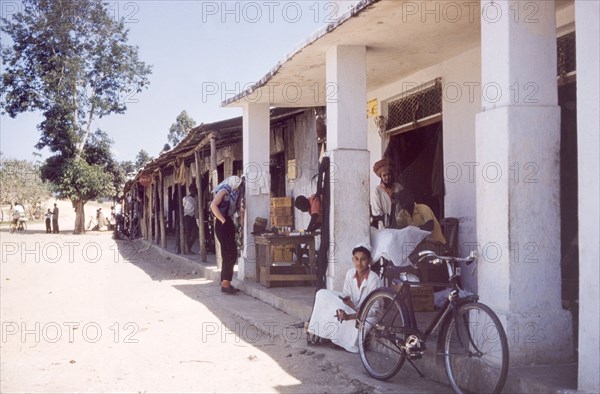 Dukas on the Tanganyika-Uganda road. A row of typical East African dukas (shops) flanks the Tanganyika-Uganda road. Kyaka, Tanganyika Territory (Tanzania), August 1960., Kagera, Tanzania, Eastern Africa, Africa.