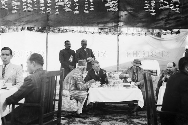 Taking tea with Sir Maurice Hallett. Reception at Jansath near Muzzaffarnagar. Seated centre left to right: Khan Bahadur Sayed Abdullah Khan: Sir Maurice Hallett, Governor of Unitied Provinces: Mrs Lynch, wife of J V Lynch, District Magistrate Muzaffarnagar. Jansath, United Provinces (Uttar Pradesh), India, 2 January 1942., Uttar Pradesh, India, Southern Asia, Asia.