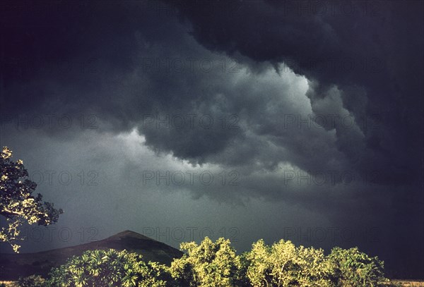 Storm over Lake Saka. Heavy black storm clouds gather over Lake Saka. Near Fort Portal, West Uganda, 1955., West (Uganda), Uganda, Eastern Africa, Africa.