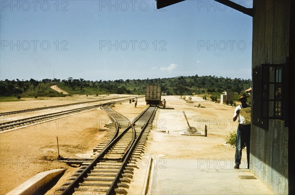 Kamwenge railway station, 1957. View from the platform of the newly completed Kamwenge railway station in Toro. The station was constructed on the Western Ugandan Extension, a section of railway track built to transport partially refined copper ore down country. Kamwenge, West Uganda, 1957. Kamwenge, West (Uganda), Uganda, Eastern Africa, Africa.