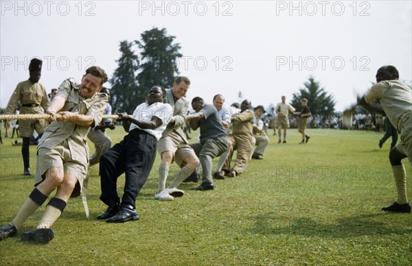 Tug of war in Toro. British and Ugandan men of the Protectorate Police team take part in a tug of war during a sports day in Toro. West Uganda, 1956., West (Uganda), Uganda, Eastern Africa, Africa.