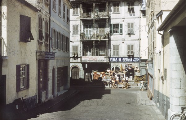 A street in Gibraltar. A horse-drawn carriage travels along a city street in Gibraltar. Gibraltar, July 1958. Gibraltar, Gibraltar, Gibraltar, Mediterranean, Europe .