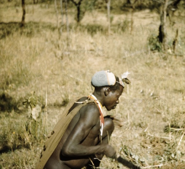 Road builder hard at work. A Karamojong porter helps to construct the Timu Road in Karamoja. Former District Forest Officer James Lang Brown comments: "Motivating one's road building workers was not easy. We tempered our pace to suit local custom". North East Uganda, 1958., North (Uganda), Uganda, Eastern Africa, Africa.