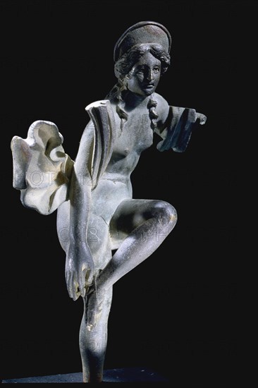 A statue of a Dancing Venus with flowing drapery and an arching canopy over her head