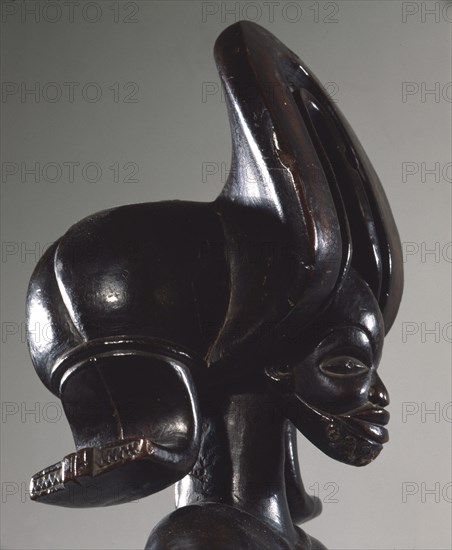 Wood figure of wearing headdress that is characteristic of Chokwe chiefs and also found on important masks