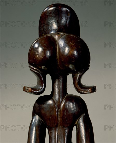 Wood figure of wearing headdress that is characteristic of Chokwe chiefs and also found on important masks