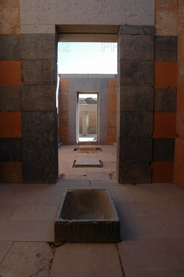 Interior view of the Red Chapel of Hatshepsut showing a granite lustral basin