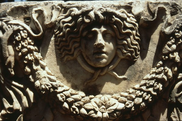 Relief of Medusa head encircled by snakes and garland from a stone sarcophagus