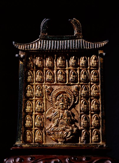 Miniature gilt bronze reliquary in the form of a building, dating from the late Tang dynasty, ornamented with miniature Buddhas in relief around the central image of the Bodhisattva Guanyin seated on a lotus