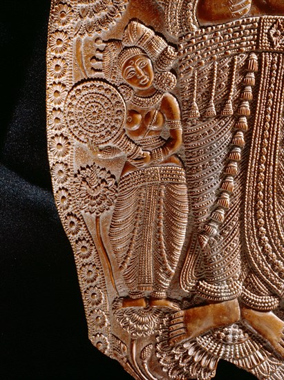 Carving of a goddes holding a lotus flower