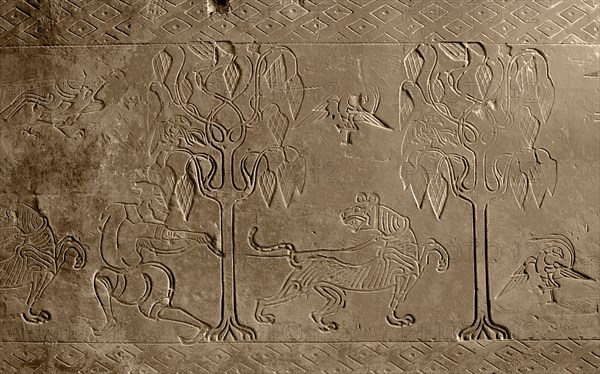 Brick from a tomb structure impressed with design of a man, tree, birds and a tiger