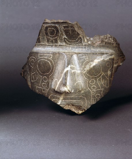 Fragment of a carved stone face with a weeping eye incised design similar to the so called Weeping God on the Gateway of the Sun at the ceremonial centre of Tiahuanaco