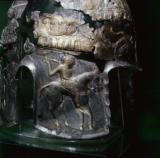 Detail of the design on a helmet, showing a horseman with a spear