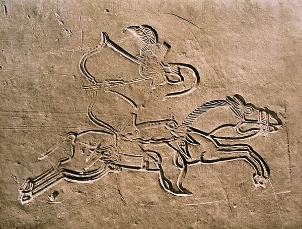 A brick from a tomb structure with a design of a warrior executing a Parthian shot whilst riding his galloping horse
