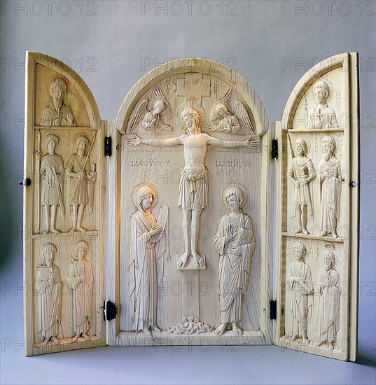 A triptych for private devotional use carved with the Crucifixion attended by the archangels Michael and Gabriel, the Virgin and St John