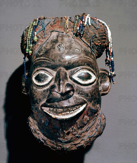 The beard and raffia cap depicted on this mask headdress indicate that an important titled man is represented