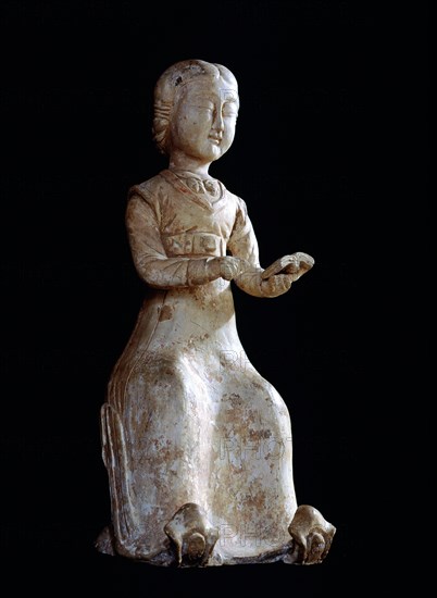 Figure of a seated woman reading a book