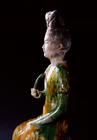 Figure of a seated court lady holding a lotus stem