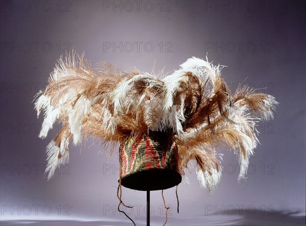 Fez style hat of coloured llama threads looped into coils decorated with triangular and step volute design