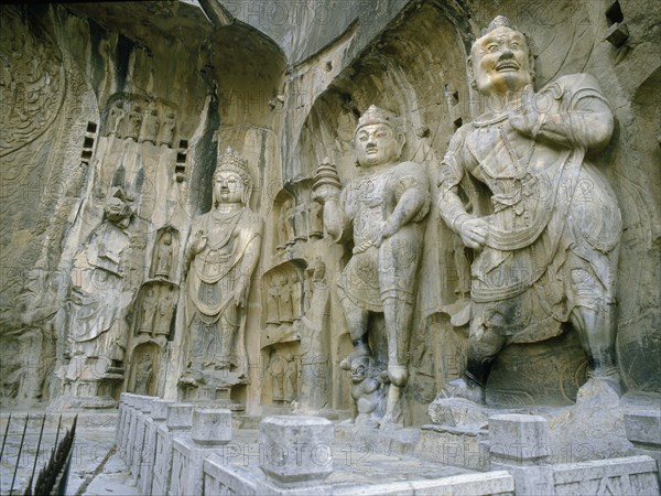 The guardian kings of Buddhism carved on the north wall of the Fengxian temple at the Longmen cave temple complex