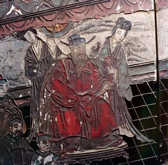 Detail fron a lacquer screen depicting a dignitary with two maid servants