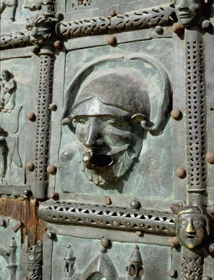 Detail of the bronze door of the Basilica of San Zeno which is decorated with 48 panels illustrating biblical stories and the lives of St Peter, St Paul, St Zeno, St Helena among others, and items connected with music and the three Theological Virtues