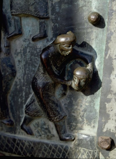 Detail of the bronze door of the Basilica of San Zeno which is decorated with 48 panels illustrating biblical stories and the lives of St Peter, St Paul, St Zeno, St Helena among others, and items connected with music and the three Theological Virtues