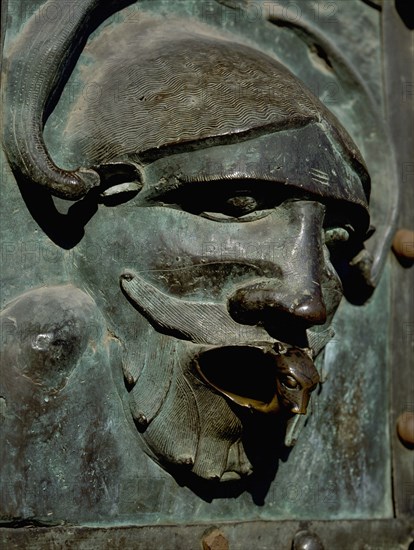 Detail of the bronze door of the Basilica of San Zeno which is decorated with 48 panels illustrating biblical stories and the lives of St Peter, St Paul, St Zeno, St Helena among others, and items connected with music and the three Theological Virtues