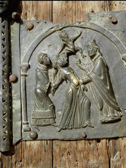 Detail of the bronze door of the Basilica of San Zeno which is decorated with 48 panels illustrating biblical stories and the lives of St Peter, St Paul, St Zeno, St Helena among others, and items connected with music and the three Theological Virtues