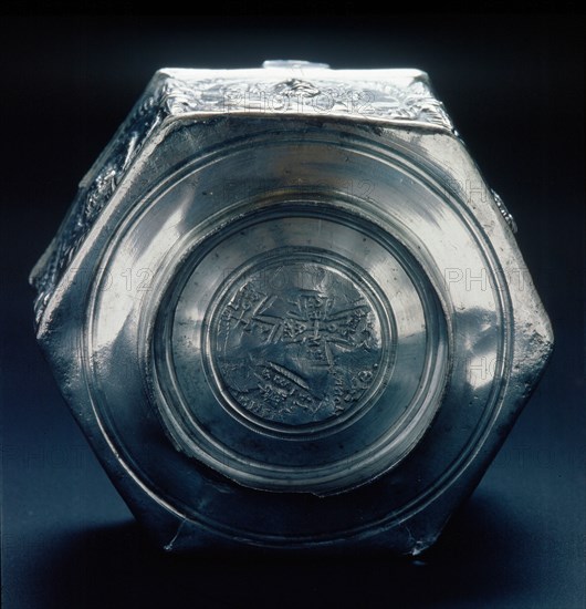 The base of a six sided silver vessel which is marked by a control stamp