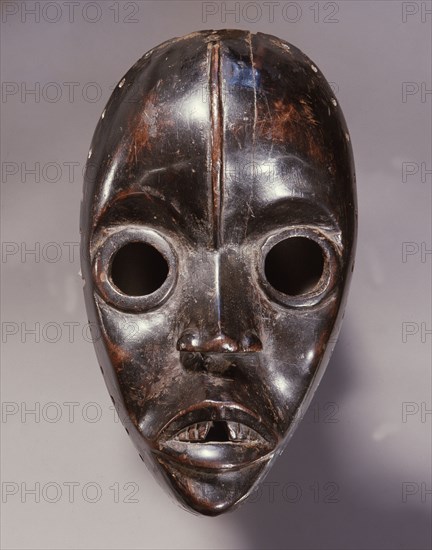 Mask of a type called Zakpei, whose sole function is to patrol northern Dan villages during the dry season making sure that women extinguish their cooking fires before the onset of winds that whip up each afternoon
