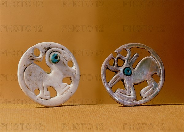 Pendants, one with a bird design, one with a deer