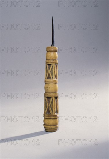 Sewing awl with a carved bone handle