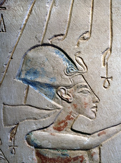 Sunk relief from the facade of a shrine showing Akhenaten and Nefertiti offering libations to Aten, the sun god