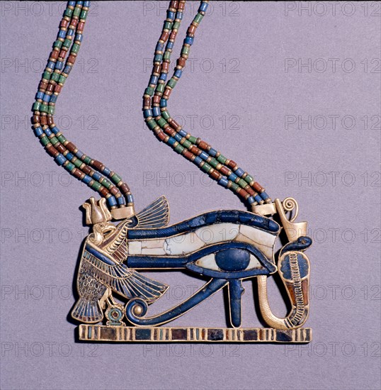 A pendant from the tomb of Tutankhamun in the form of a Wedjat eye, symbol of protection, flanked by the vulture goddess, Nekhbet and the snake goddess Wadjet, protectors of Upper & Lower Egypt