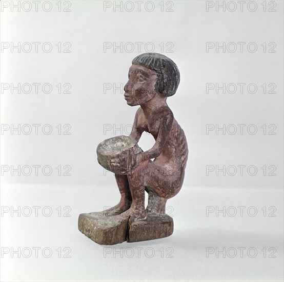 An emaciated man holding a bowl