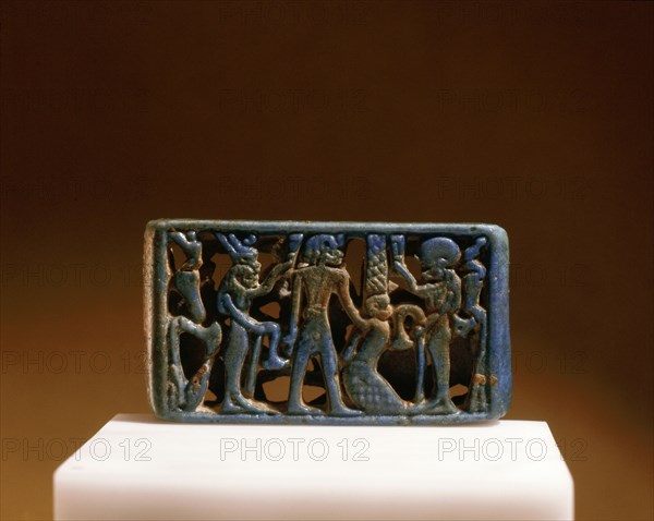 The obverse of a blue faience spacer bead