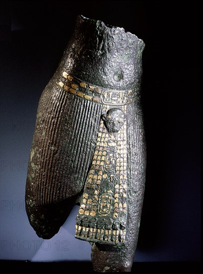 Bronze torso with belt and pleated garment decorated with copper and gold