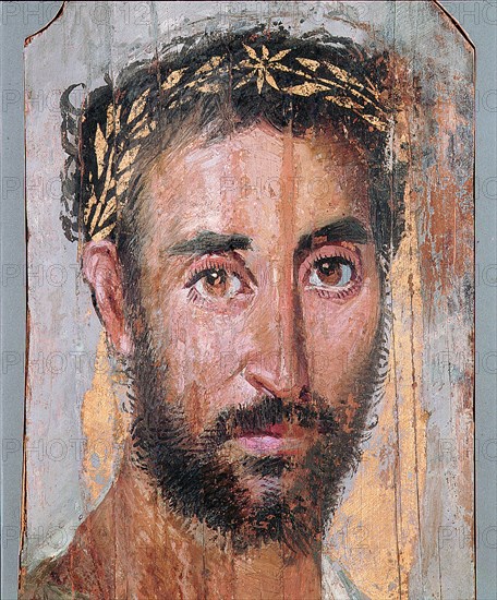 Portrait of a man wearing wreath of applied gold leaf