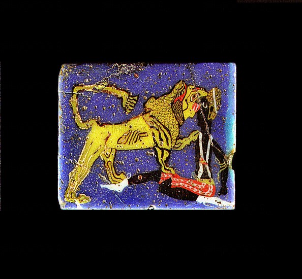 Glass plaque depicting a lion, representing the pharaoh, devouring a Nubian prisoner