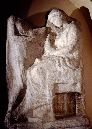 A seated young woman taking an ornament from a box presented by a servant