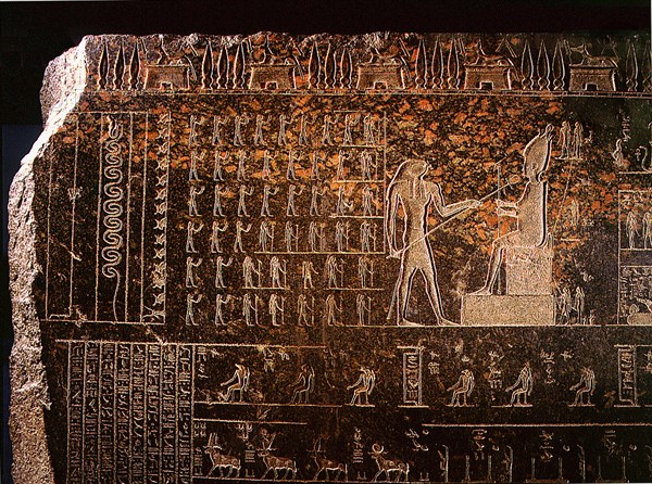 Detail from a sarcophagus depicting Horus reviving with the ankh, sign of life, his father Osiris, while standing deities raise their hands in adoration