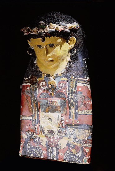 Mummy case portrait mask of a young woman with curled hair, with glass beaded bronze hoop earrings, inset beads, and glass inlay on chest depicting two orange ankh signs flanked by four Seth headed was sceptres