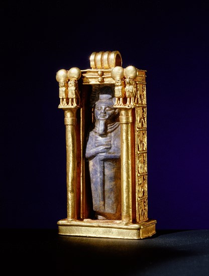 Damaged lapis lazuli amulet of the god Ptah, re used within a gold shrine, from the tomb of Wen Djeba En Djed, senior official of Psusennes I